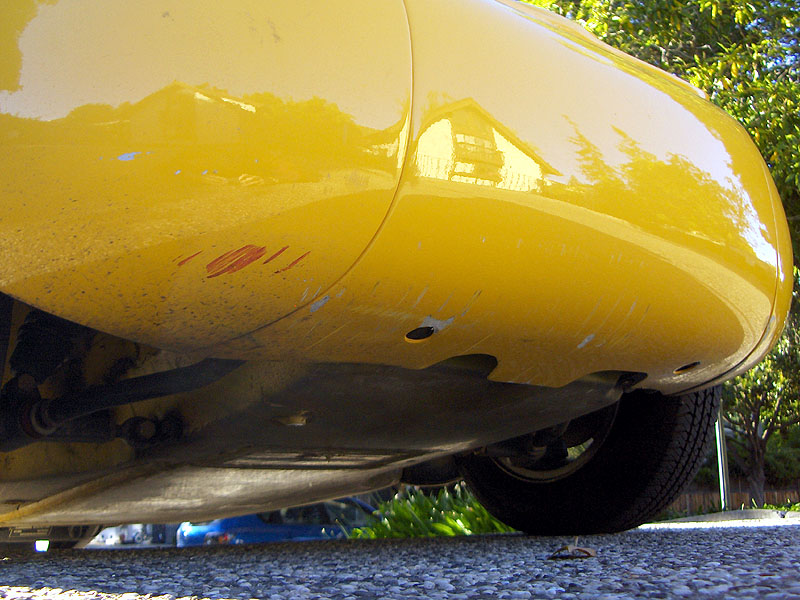 Detail of minor body scuffs on right rear panel, to right of backup light.