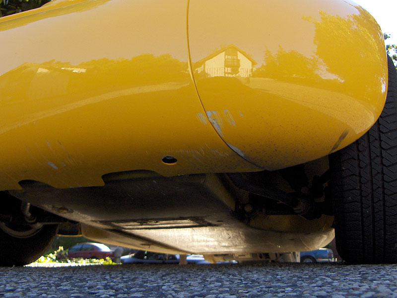 Detail of minor body scuffs on right rear panel, to right of backup light.